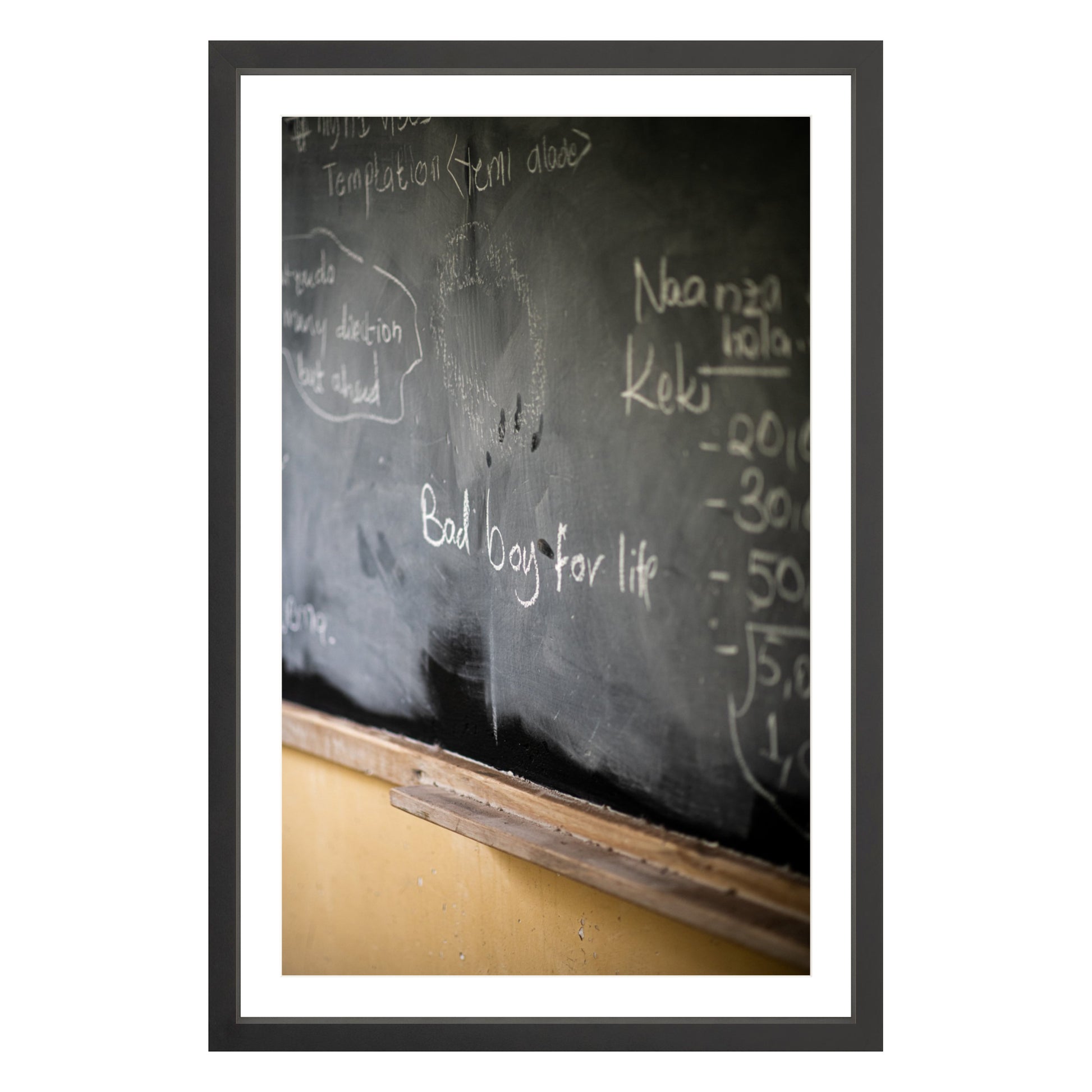 Photograph of chalkboard with "bad boy for life" written on it framed in black with white mat