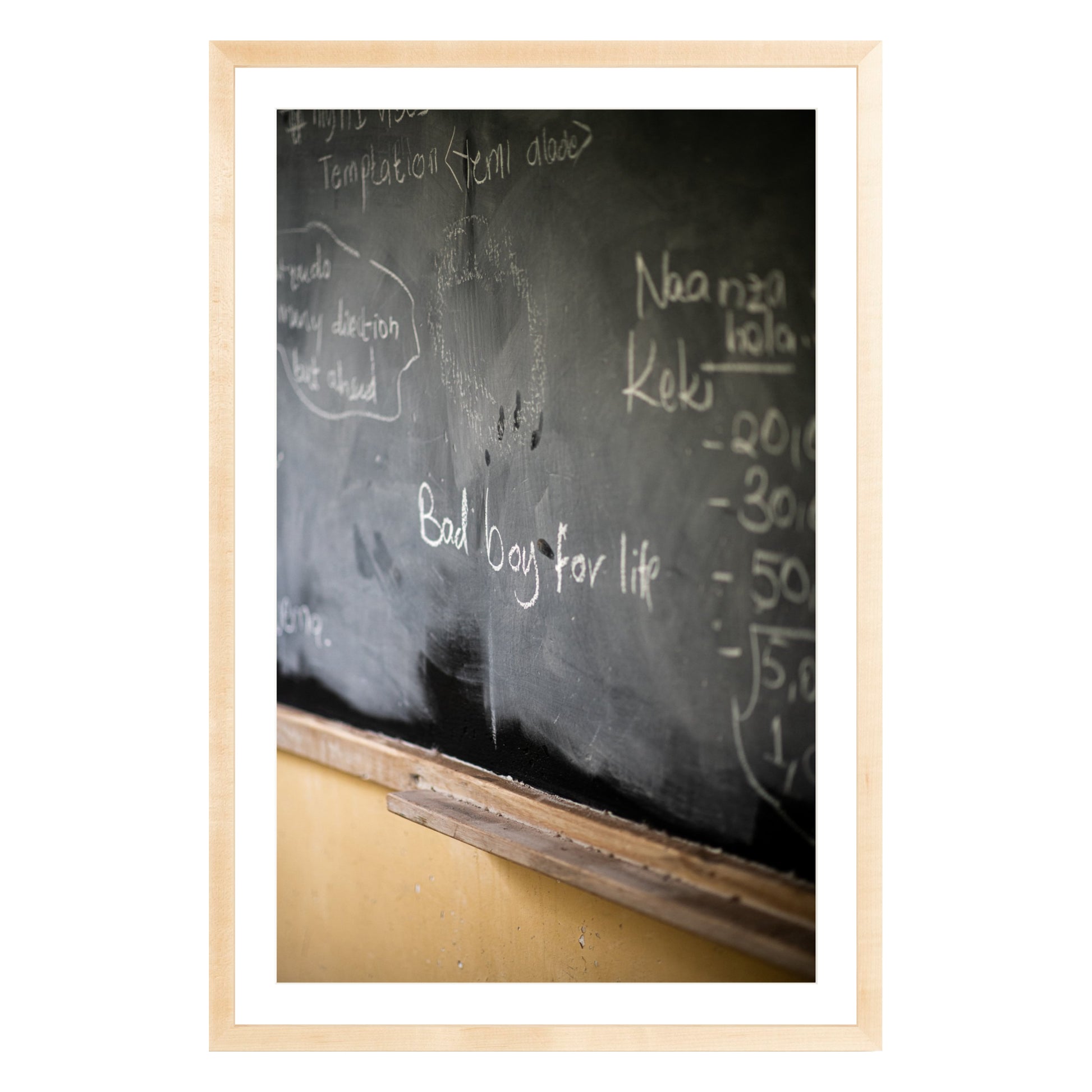 Photograph of chalkboard with "bad boy for life" written on it framed in natural wood with white mat