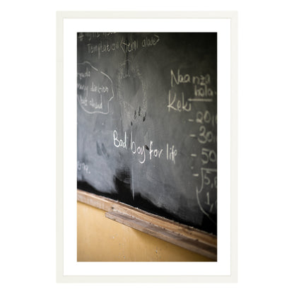 Photograph of chalkboard with "bad boy for life" written on it framed in white with white mat