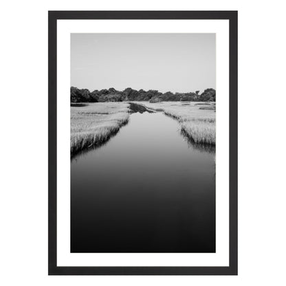 Black and white photograph of a marsh stream on Kiawah Island, South Carolina framed in black with white mat