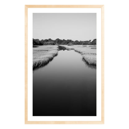 Black and white photograph of a marsh stream on Kiawah Island, South Carolina framed in natural wood with white mat