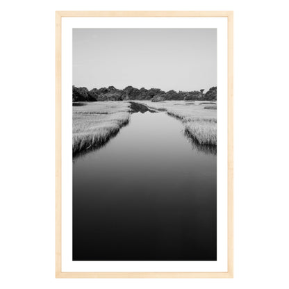 Black and white photograph of a marsh stream on Kiawah Island, South Carolina framed in natural wood with white mat