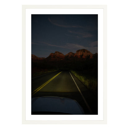 Photograph of a highway and mountains at night in Sedona Arizona framed in white with white mat