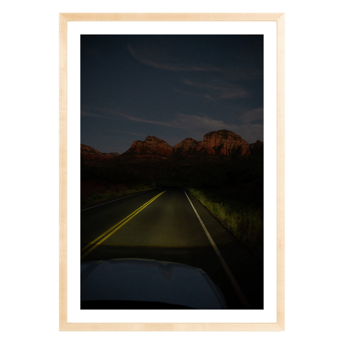 Photograph of a highway and mountains at night in Sedona Arizona framed in natural wood with white mat