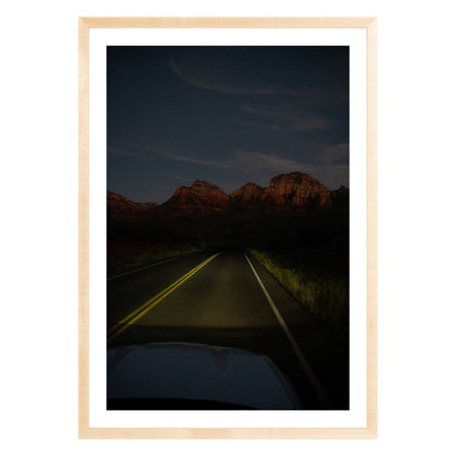 Photograph of a highway and mountains at night in Sedona Arizona framed in natural wood with white mat