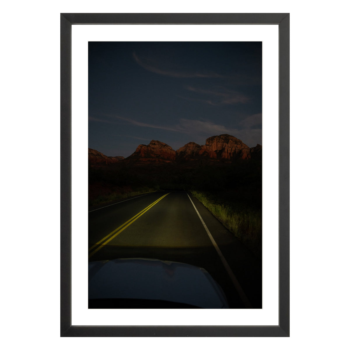 Photograph of a highway and mountains at night in Sedona Arizona framed in black with white mat