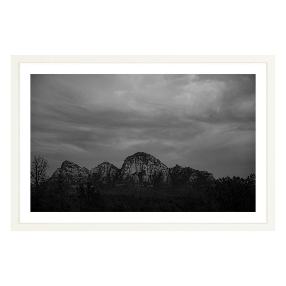 Black and white photograph of mountains in Sedona Arizona at night in a white frame with white mat