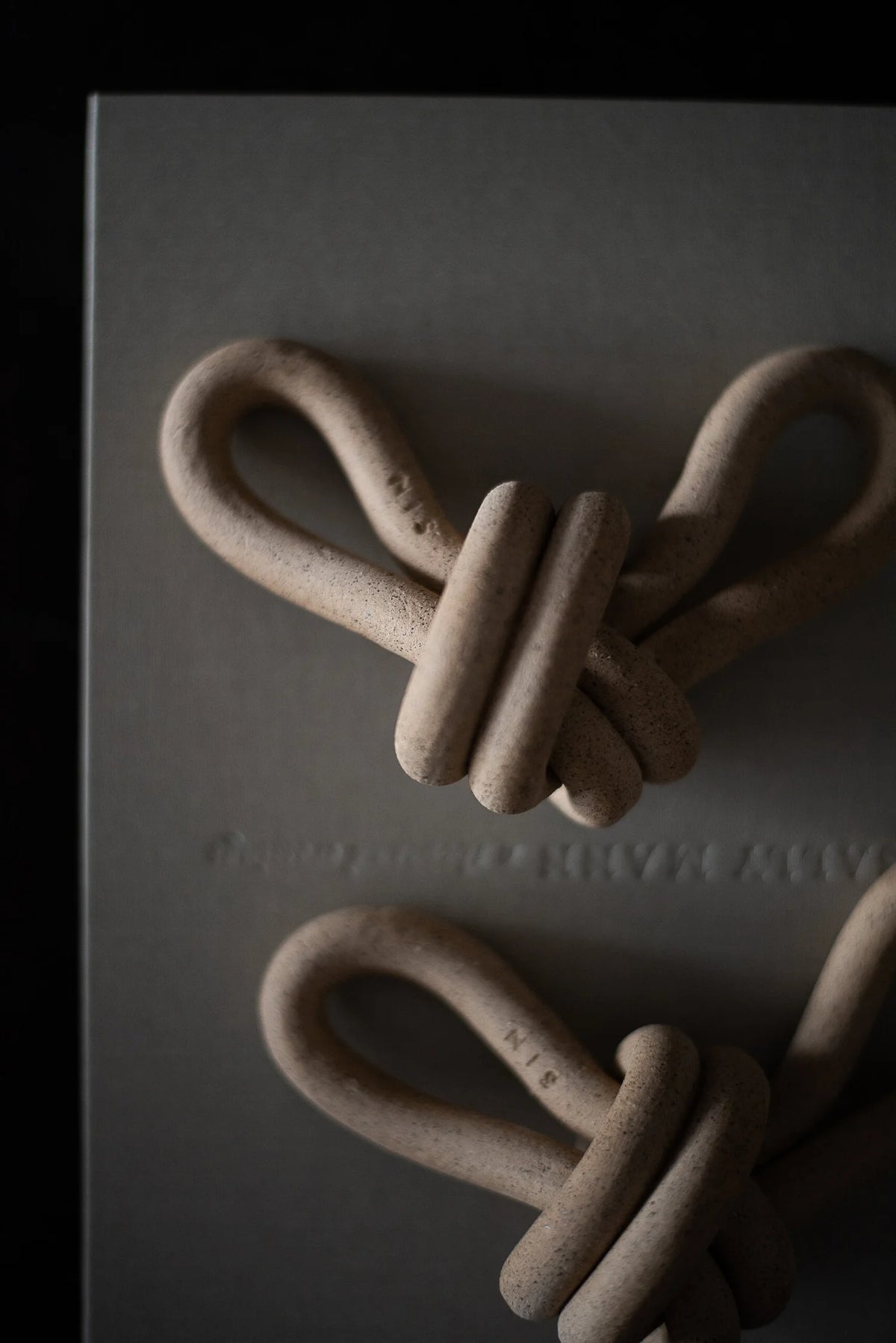 Close-up of a knotted chain on a textured surface