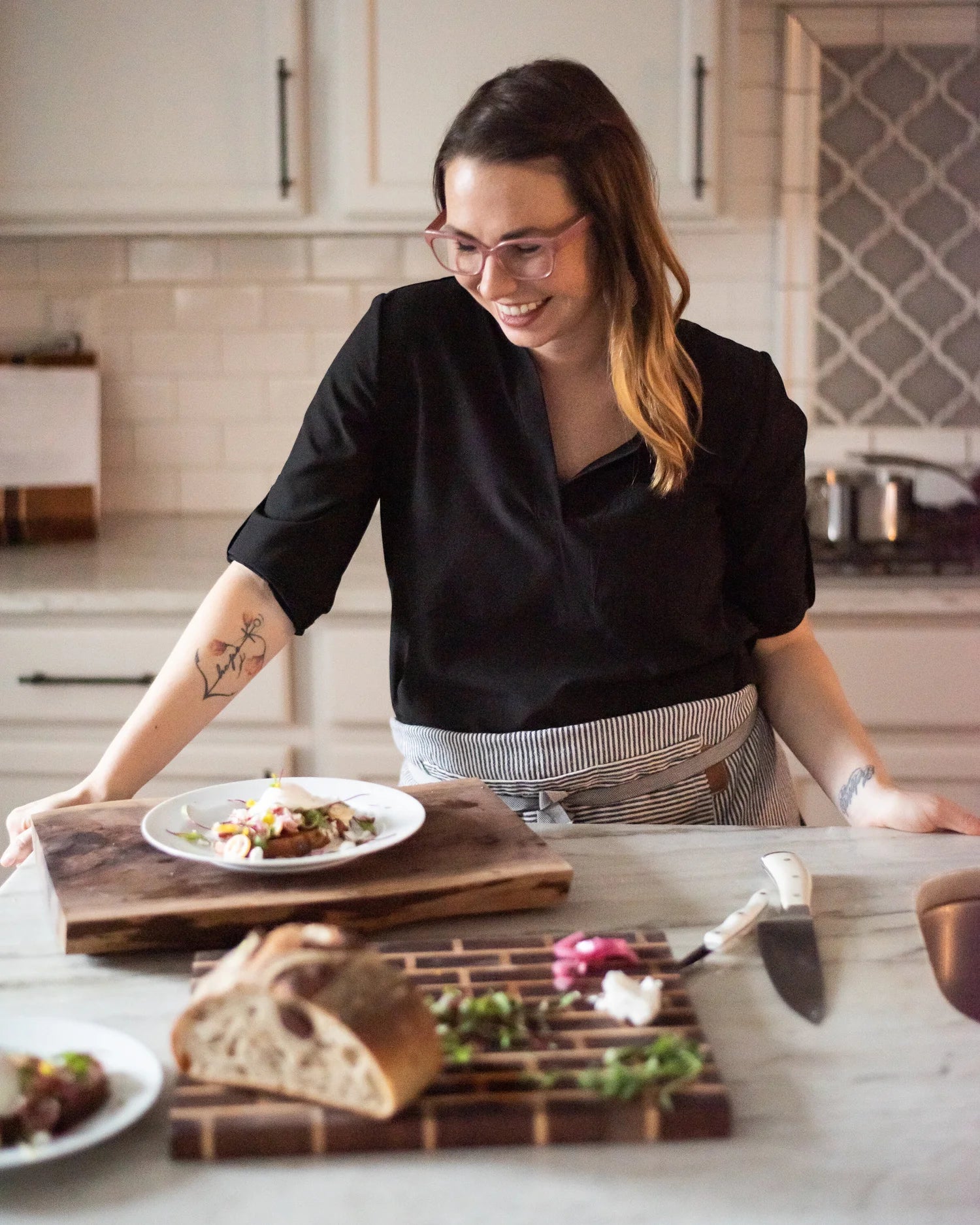 Woman in a kitchen preparing food on a counter